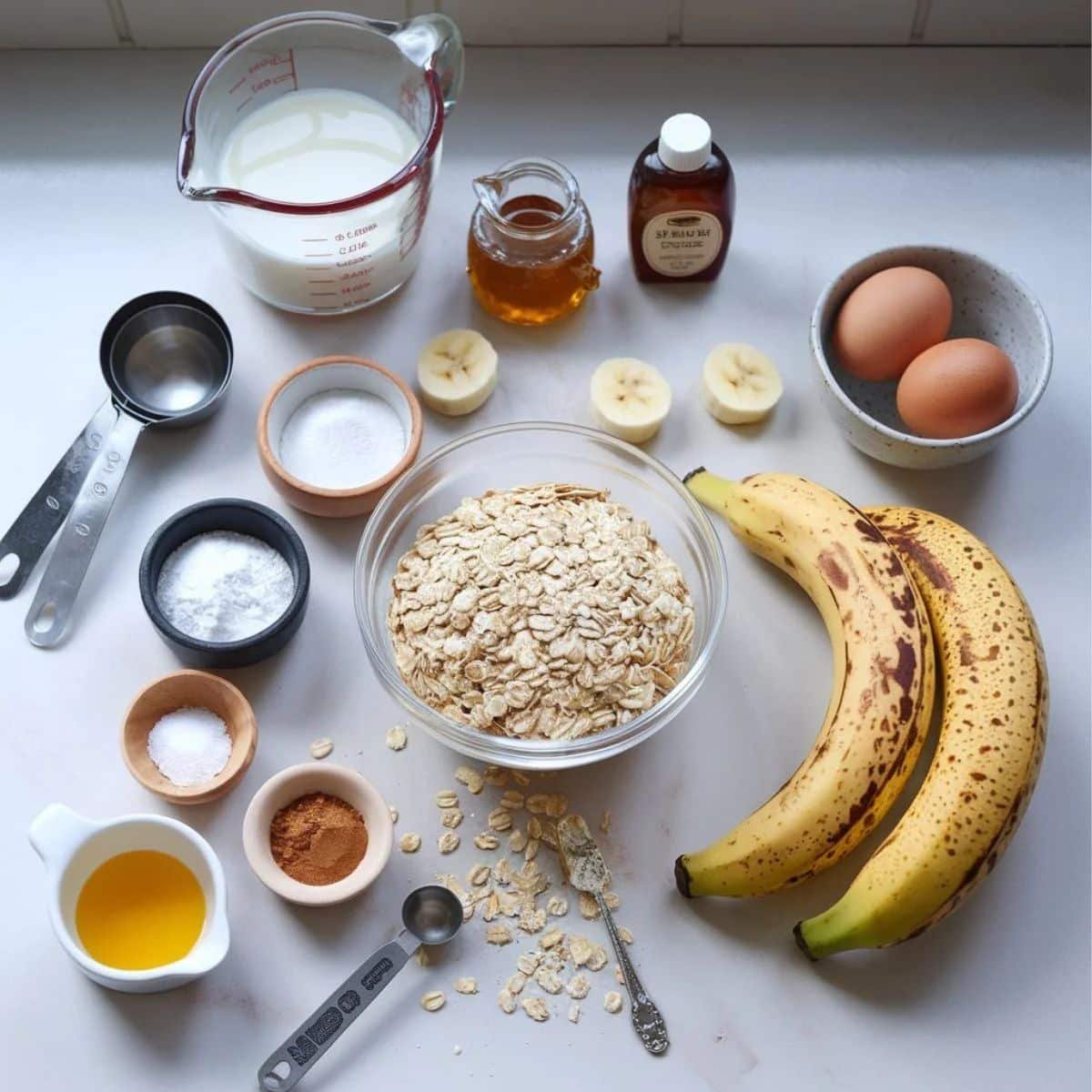 Ingredients for Banana Oat Pancakes – Ripe bananas, oats, eggs, milk, honey, cinnamon, and other pantry essentials ready for a healthy breakfast.