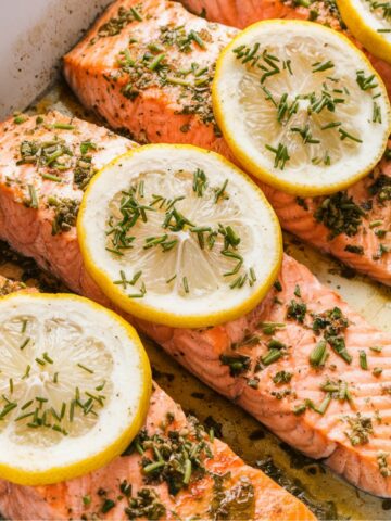 Delicious steelhead trout recipe featuring baked fillets in a buttery garlic sauce, topped with fresh lemon slices and herbs, creating a flavorful and easy seafood dish perfect for any meal.