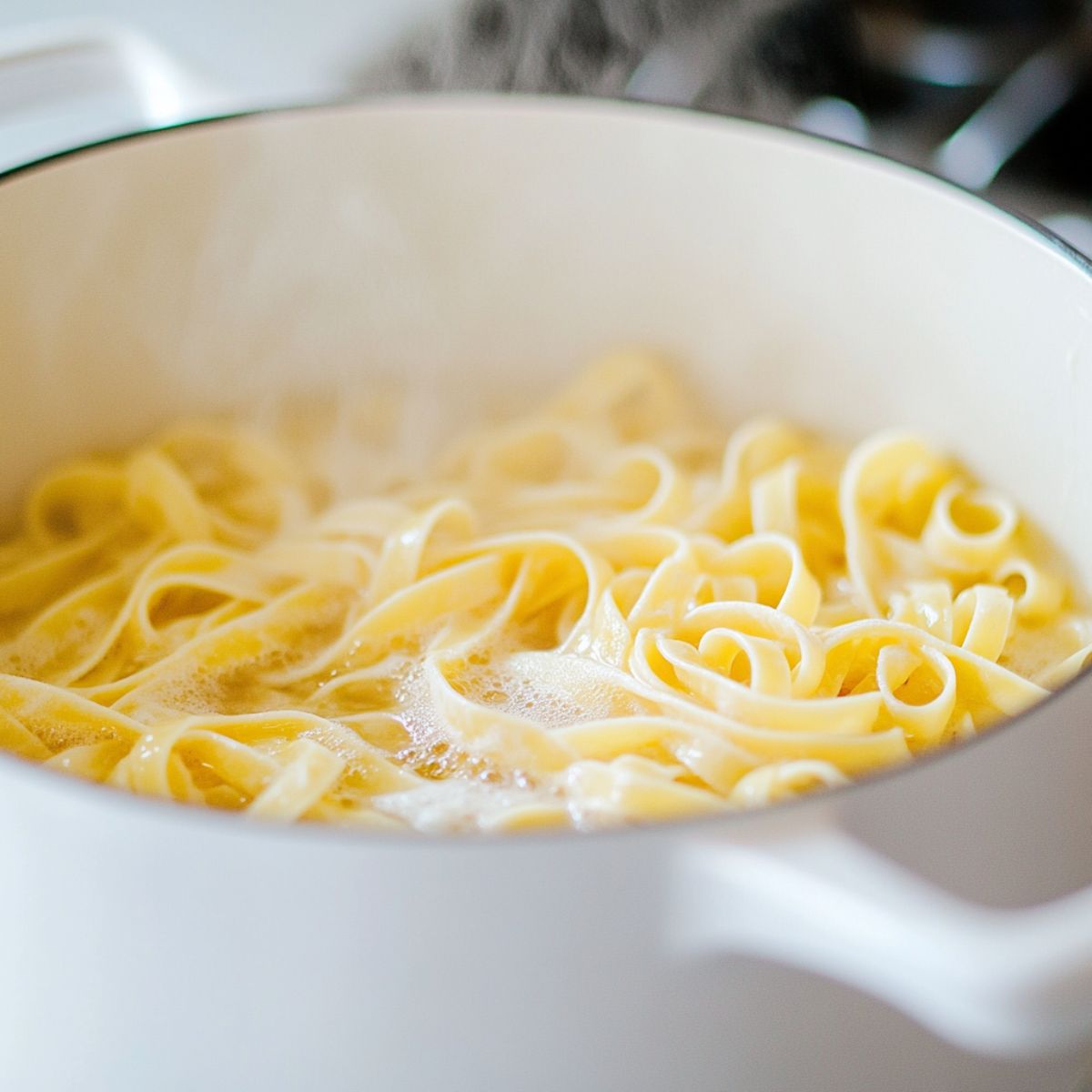 Boiling pasta in a pot with steam rising