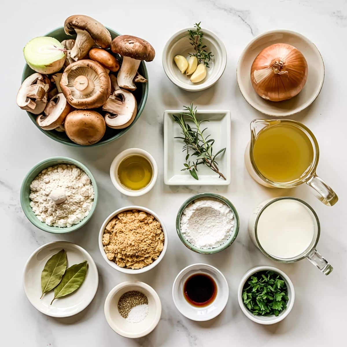 Ingredients for vegan mushroom soup on white counter