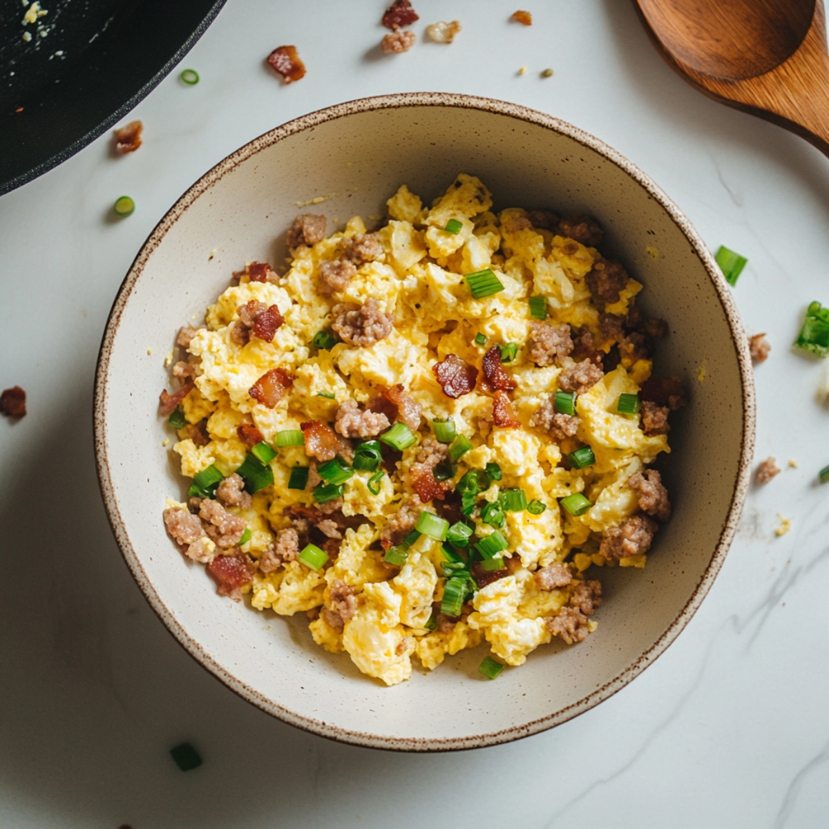 Prepping breakfast pizza rolls filling with eggs and sausage