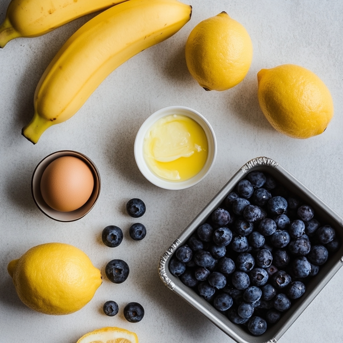 Banana bread ingredients on a white counter, ready for mixing

