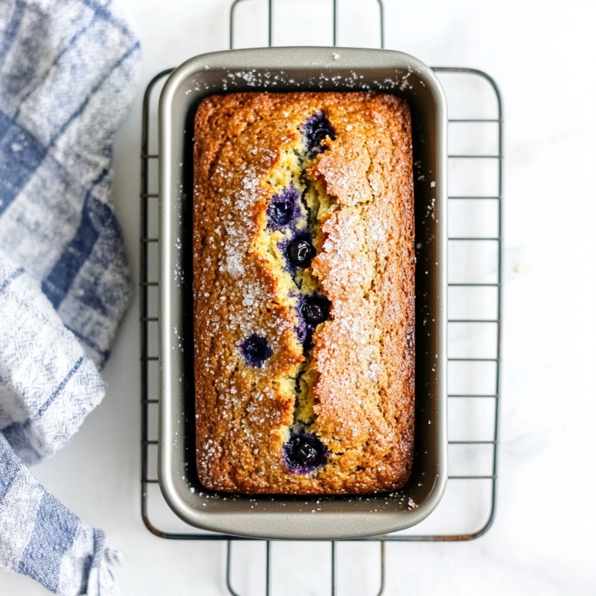 Freshly baked lemon blueberry banana bread cooling in the pan