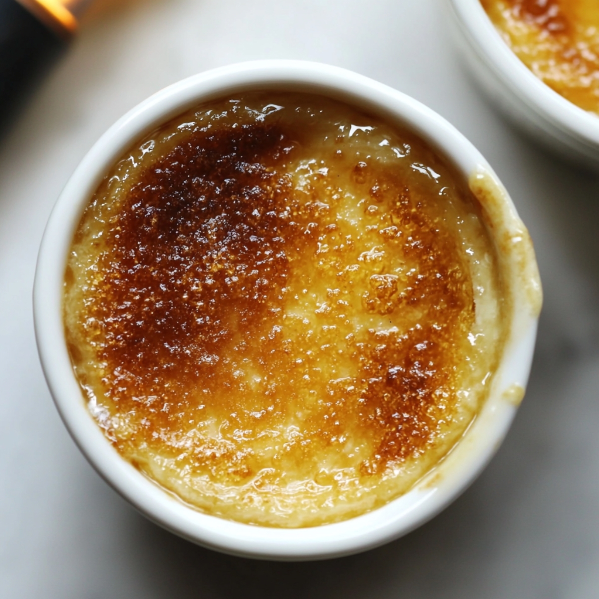 Caramelized sugar crust on ramekin for lemon posset brulee recipe