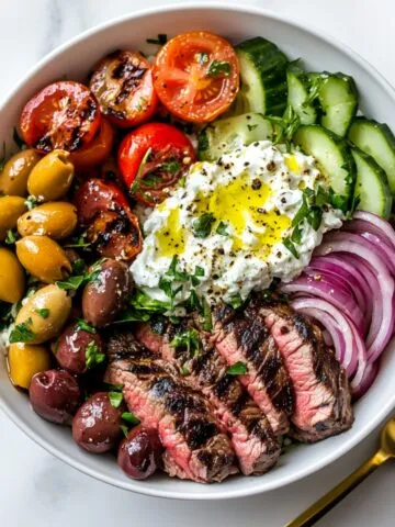 Mediterranean steak bowl with steak, tzatziki, and fresh veggies