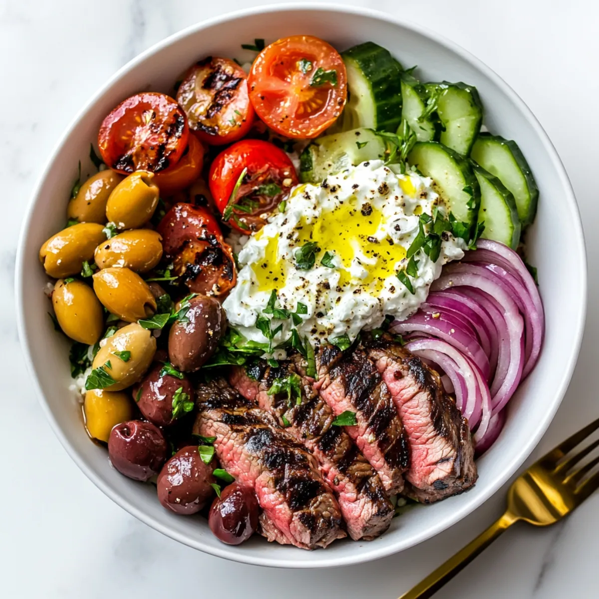 Mediterranean steak bowl with steak, tzatziki, and fresh veggies