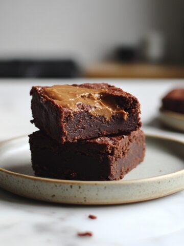 Close-up side view of fudgy protein brownies on plate