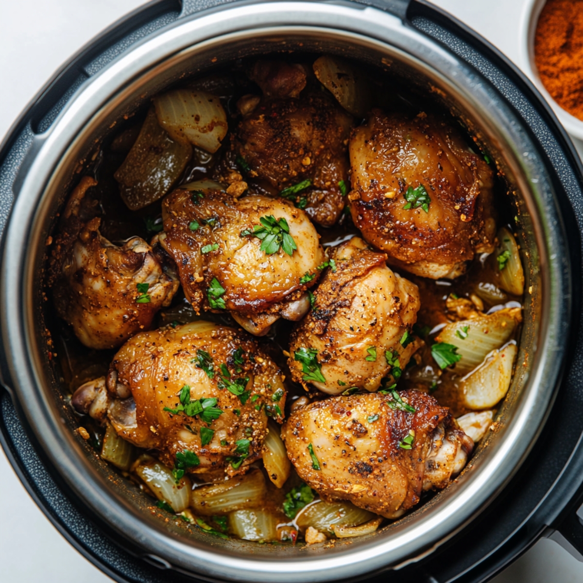 Mixed Moroccan spices and sautéed chicken with aromatics in Instant Pot.

