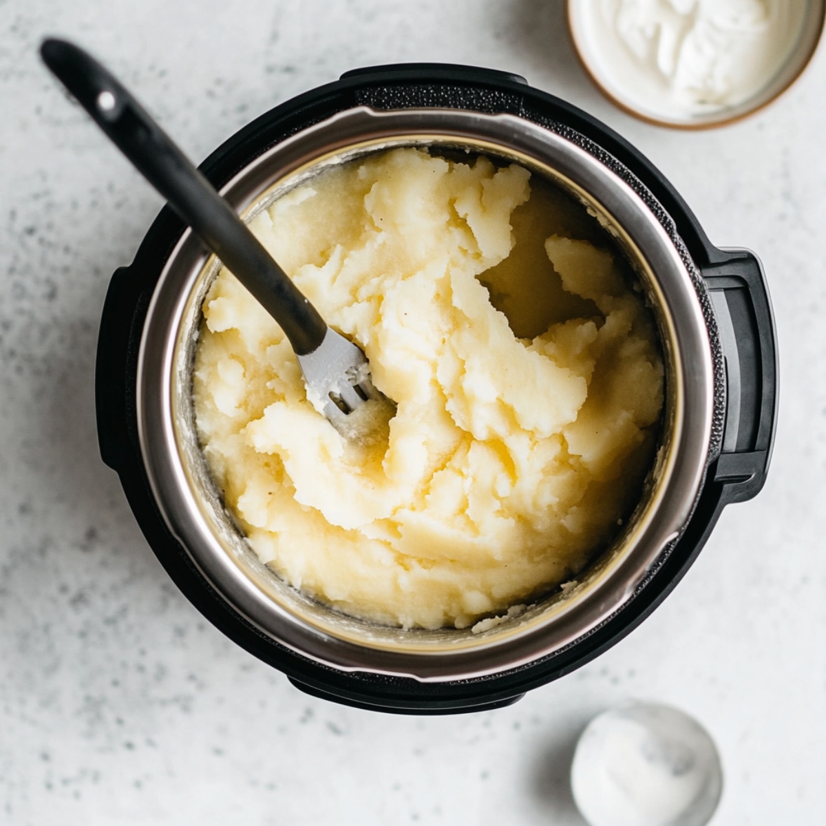 Mashed soup and cream slurry on white kitchen counter next to Instant Pot

