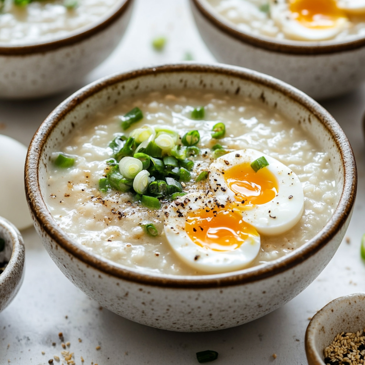 Bowl of Instant Pot chicken congee with toppings on a kitchen counter

