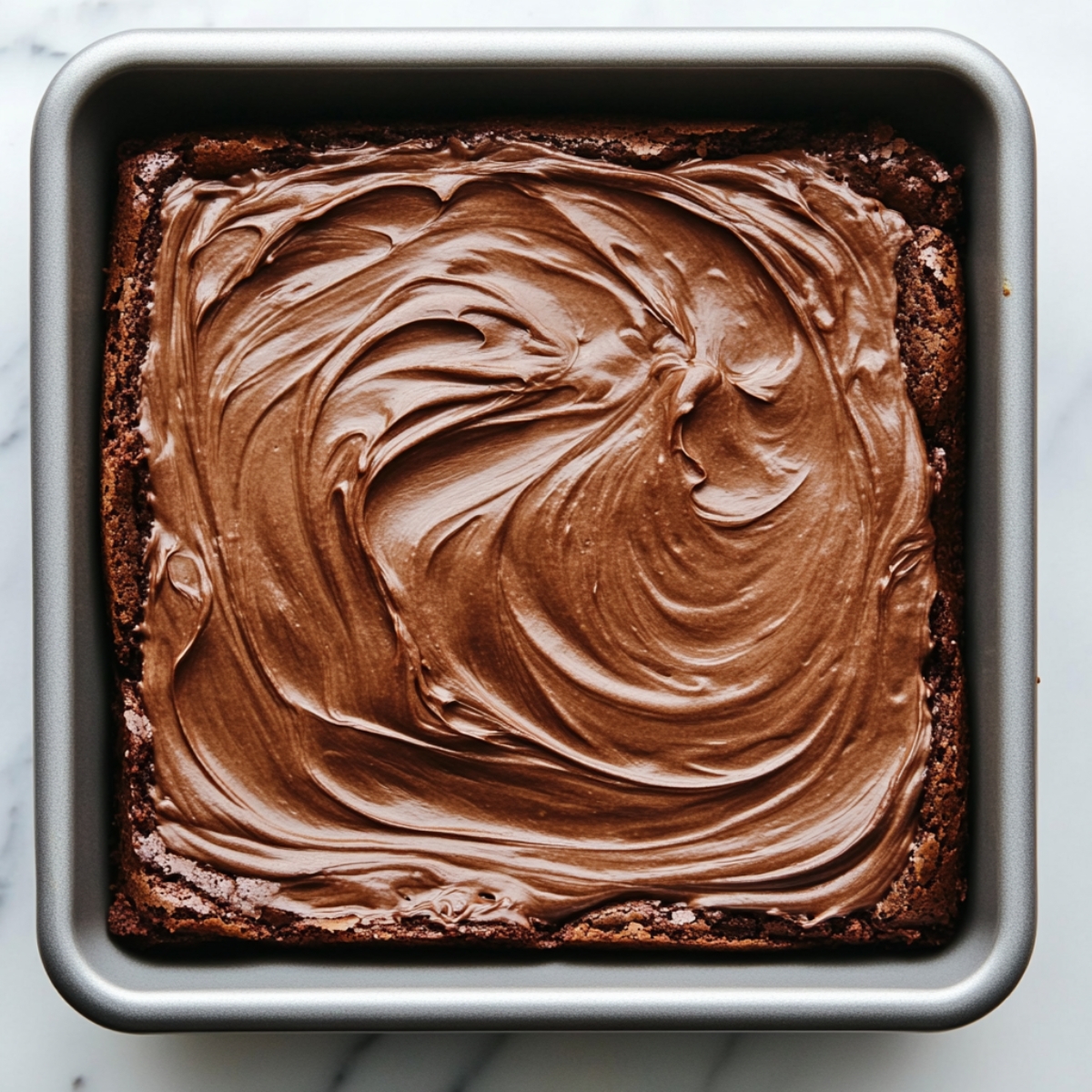 Layered chocolate mousse spread over brownie base
