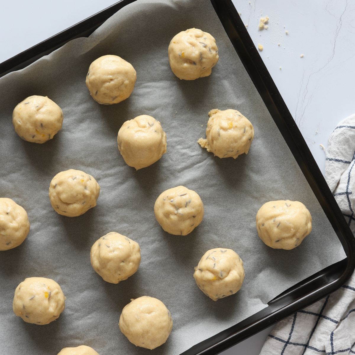 Lemon lavender cookies shaped and ready to bake on parchment