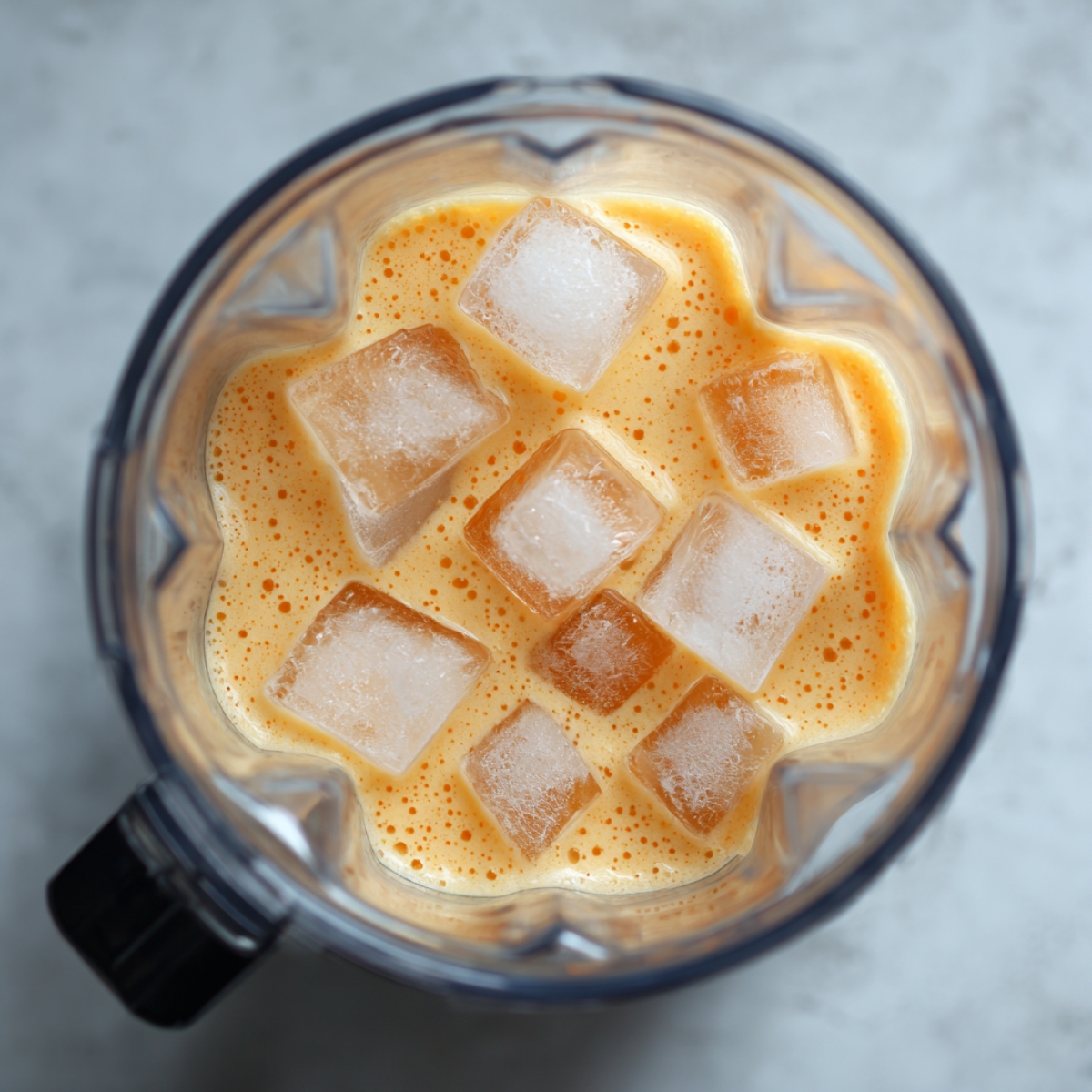 Close-up of Orange Julius smoothie mix with ice cubes before blending