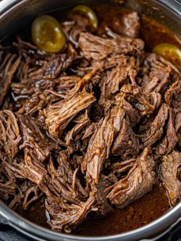 Shredded Mississippi roast in gravy inside Instant Pot