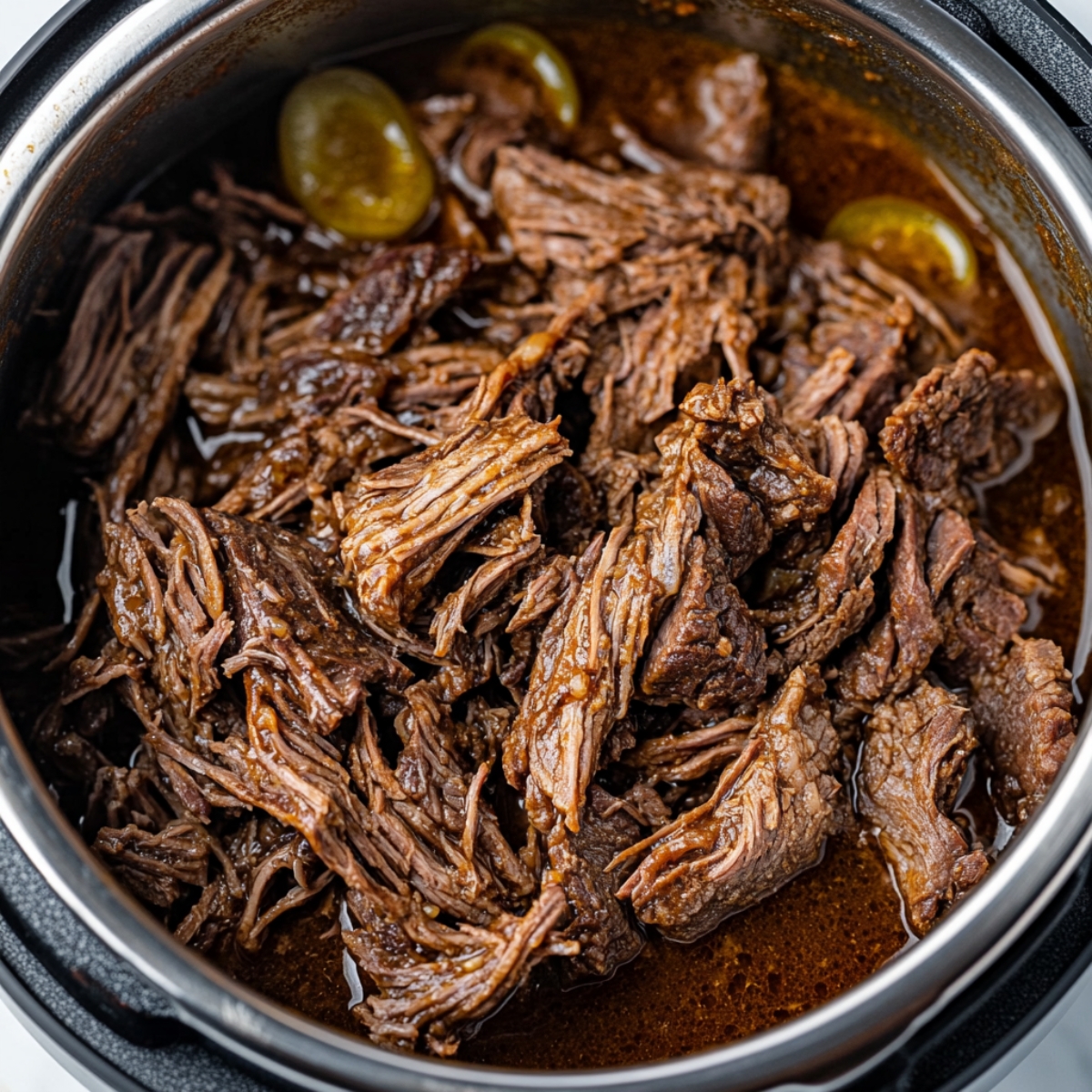 Shredded Mississippi roast in gravy inside Instant Pot