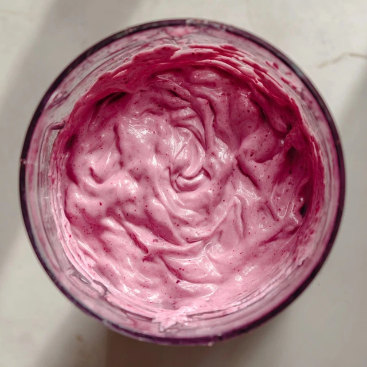 Blended berry smoothie in blender with creamy texture