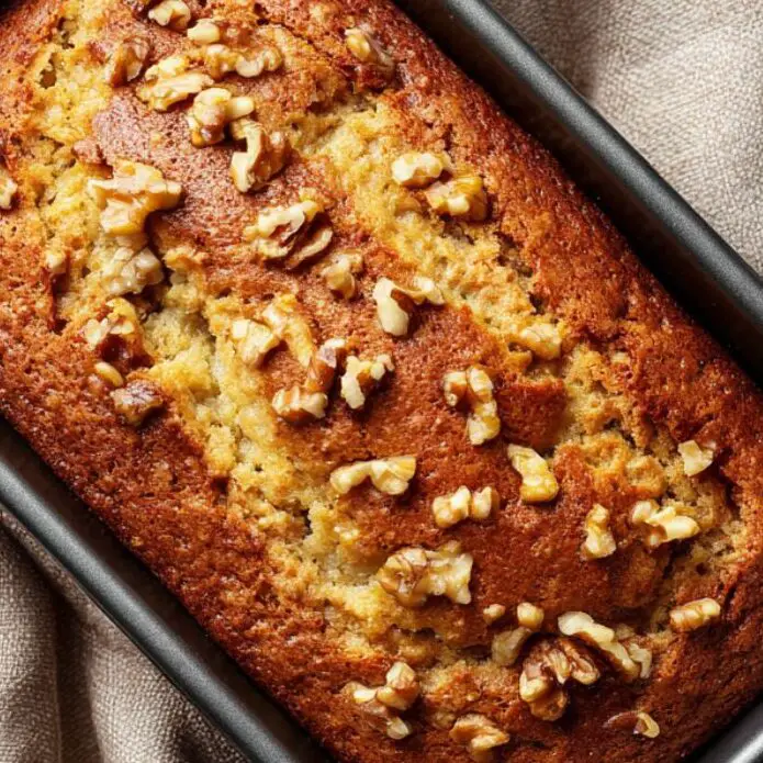 Banana walnut cake freshly baked in the pan with golden top