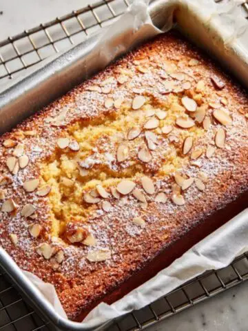 Rustic cherry almond cake with almonds and powdered sugar