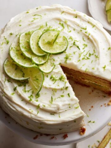 Homemade Key Lime Cake with cream cheese frosting and lime garnish