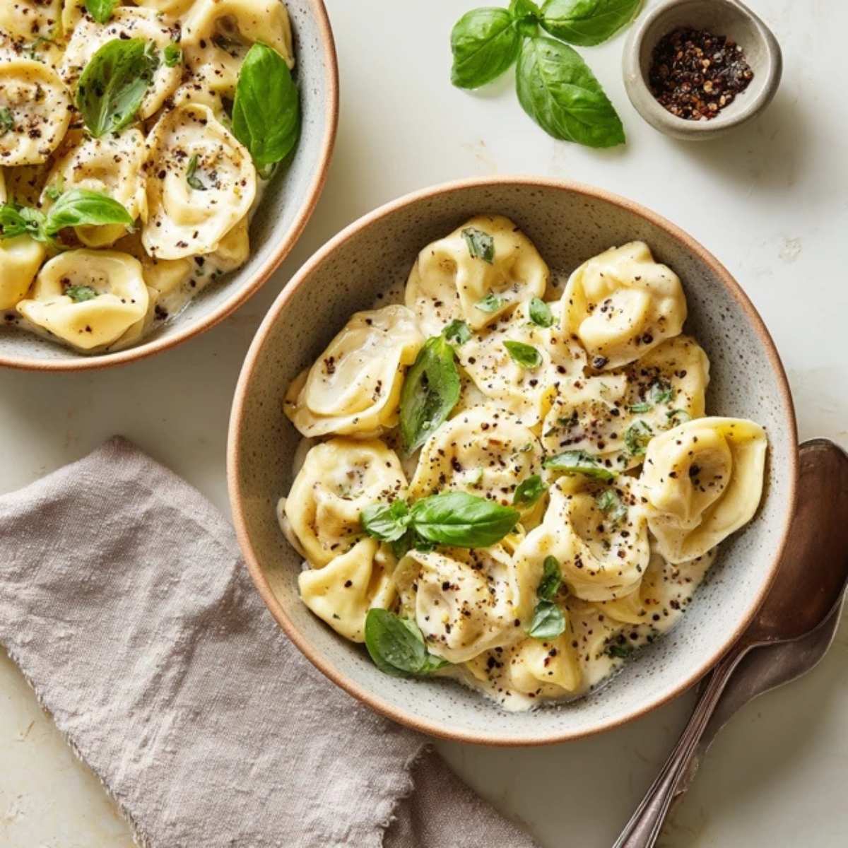 creamy Marry Me Tortellini in a bowl on white kitchen counter