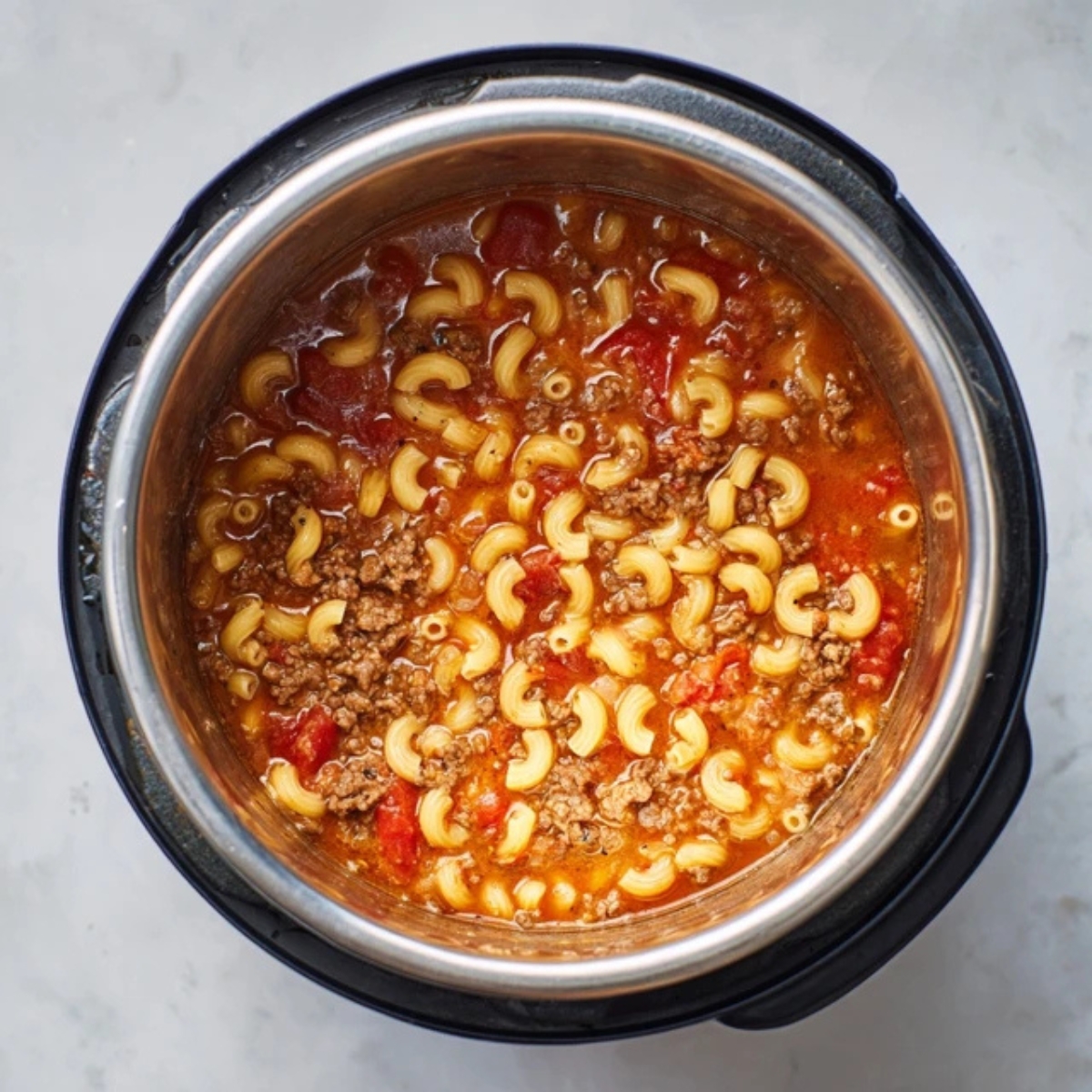 instant pot with pasta, sauce, broth, and ground beef