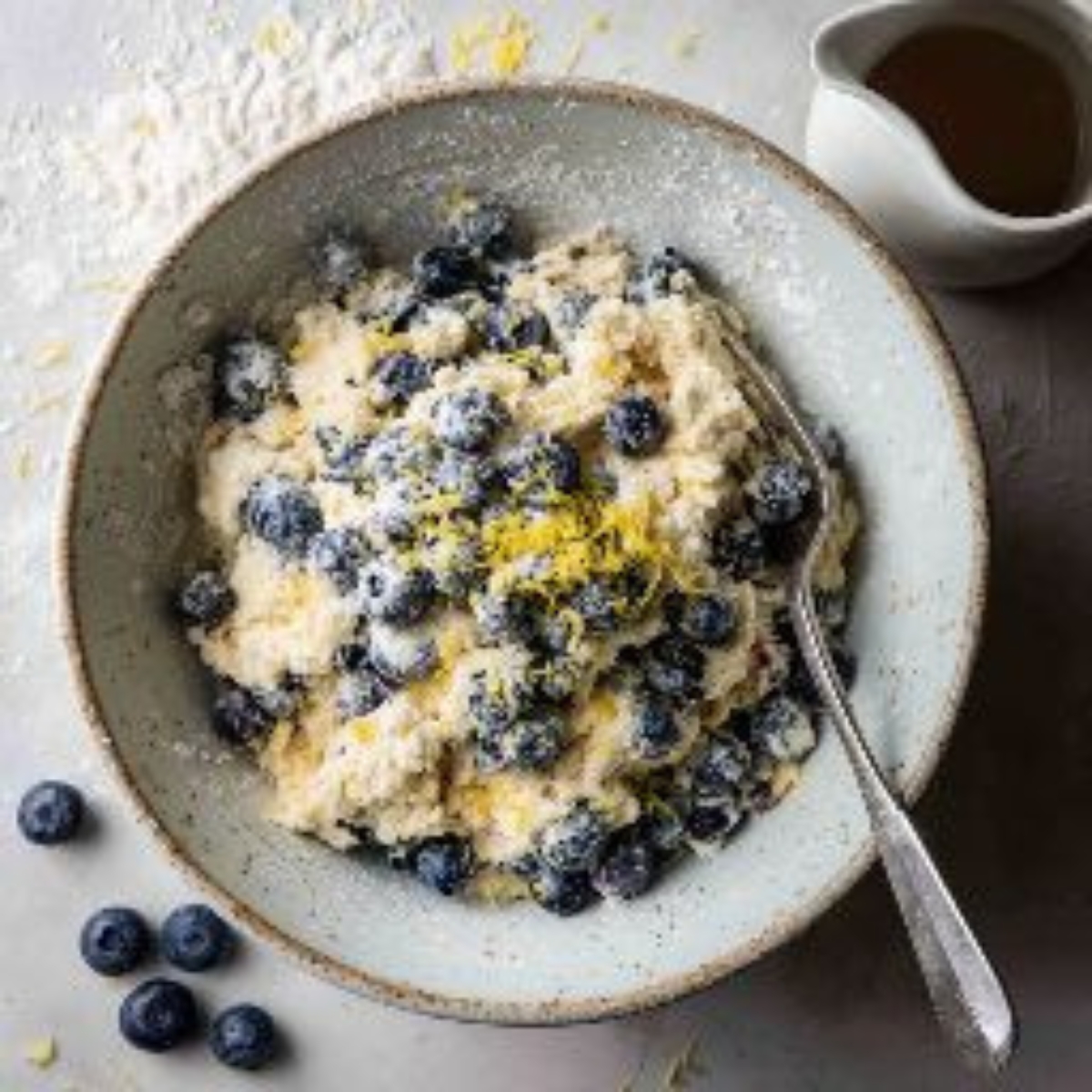 Biscuit dough with blueberries and buttermilk in bowl