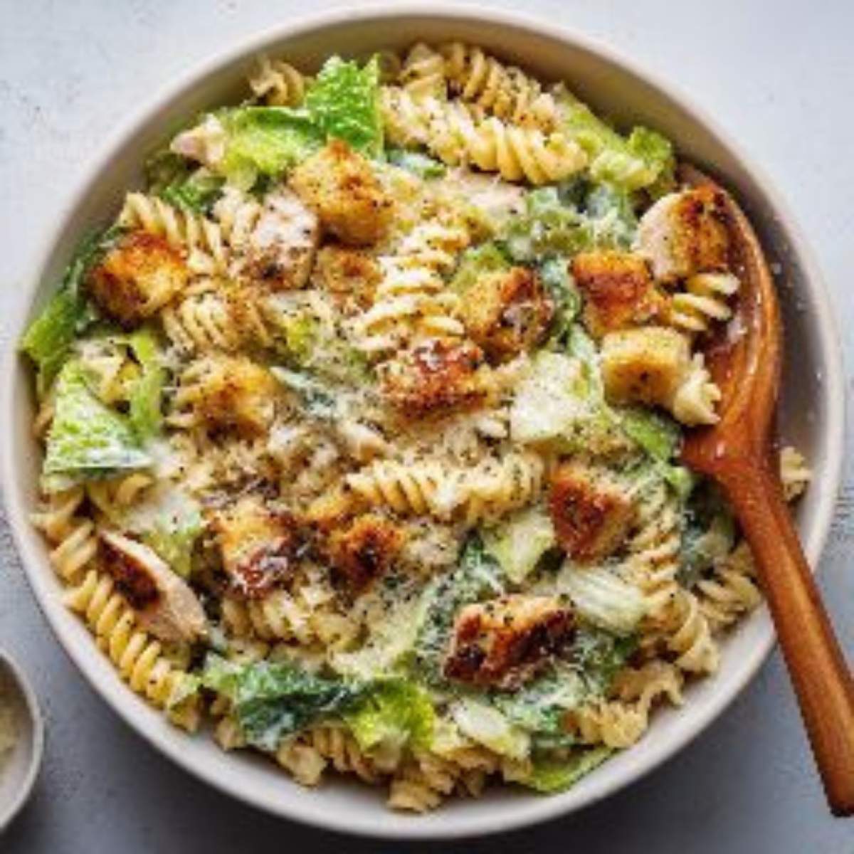  finished chicken caesar pasta salad with croutons and Parmesan