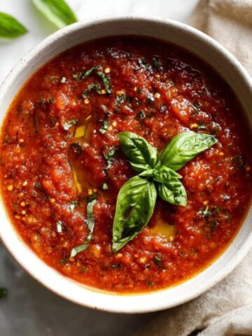 Homemade tomato basil pasta sauce in bowl with fresh basil