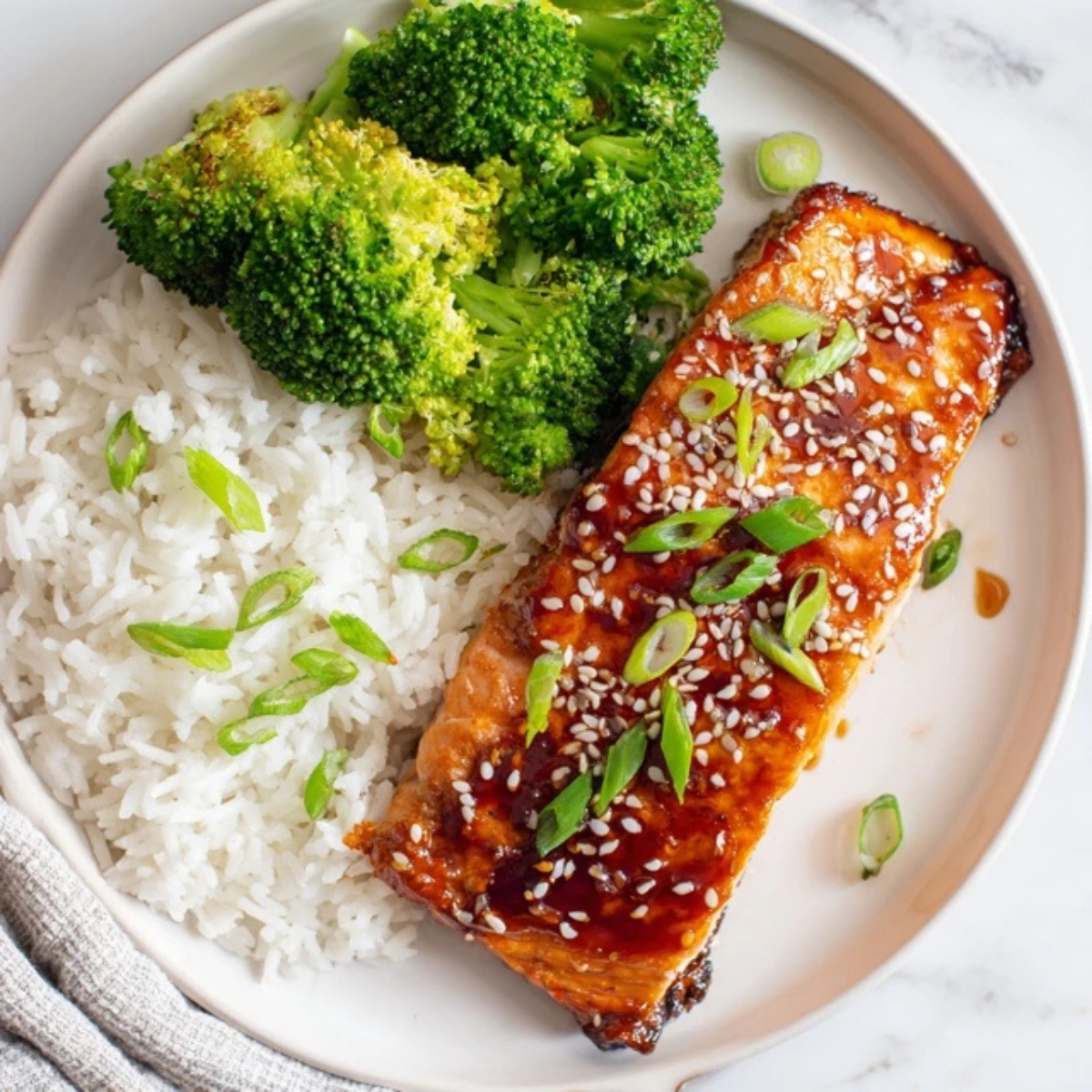 teriyaki salmon Baked with rice and broccoli on white plate