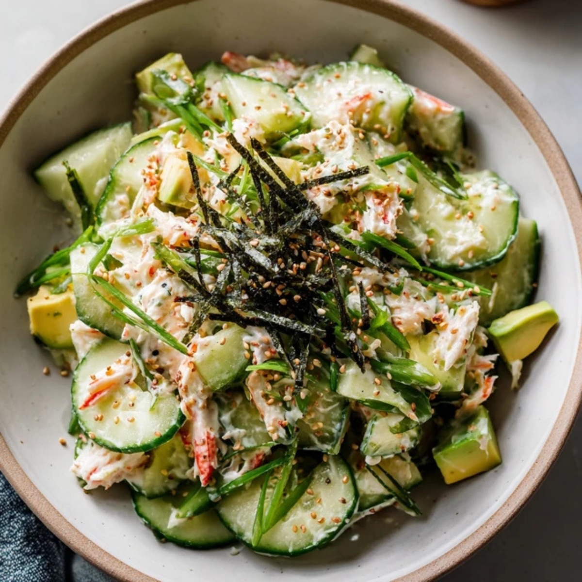 california roll cucumber salad with avocado crab and sesame seeds