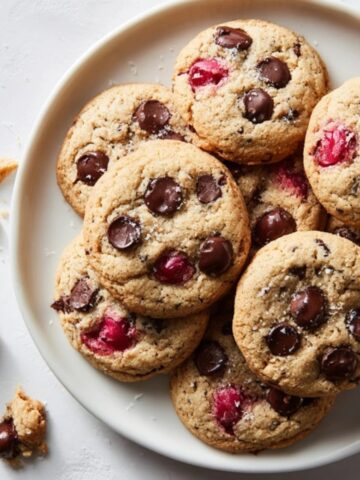 Homemade cherry chocolate chip cookies with cherries and melty chocolate on plate
