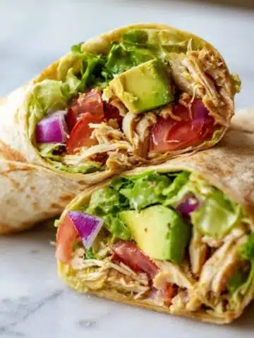 fresh chicken avocado wraps cut in half on counter