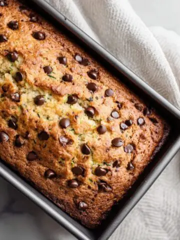 moist chocolate chip zucchini cake with melted chocolate chips on top