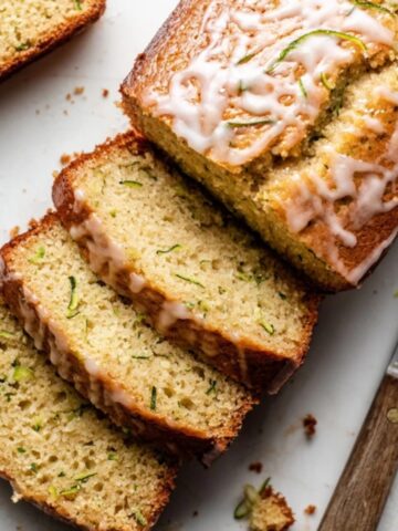 sliced lemon zucchini bread on white counter closeup