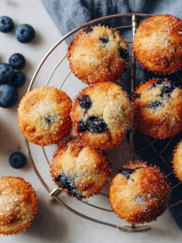fresh homemade mini blueberry muffins on cooling rack