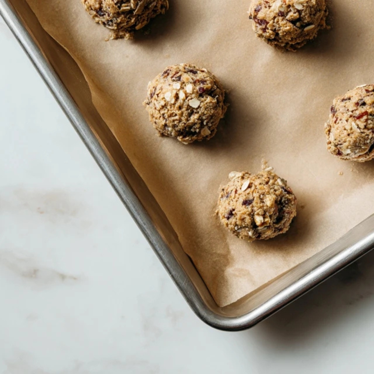 oatmeal fig cookie dough scoops on baking sheet