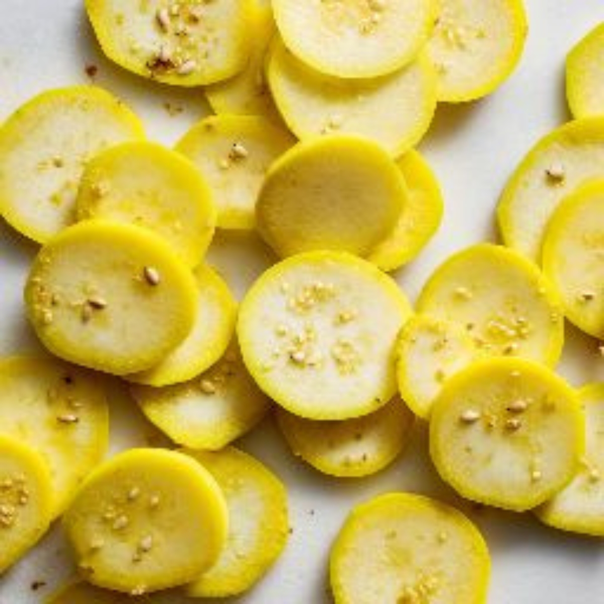 sliced yellow squash on white kitchen counter