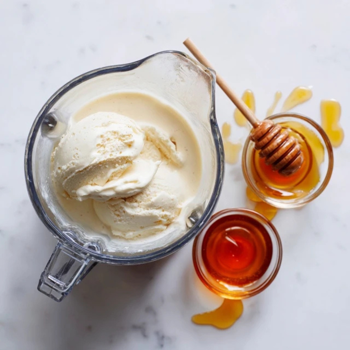 blender with almond milk, yogurt, and honey on white counter