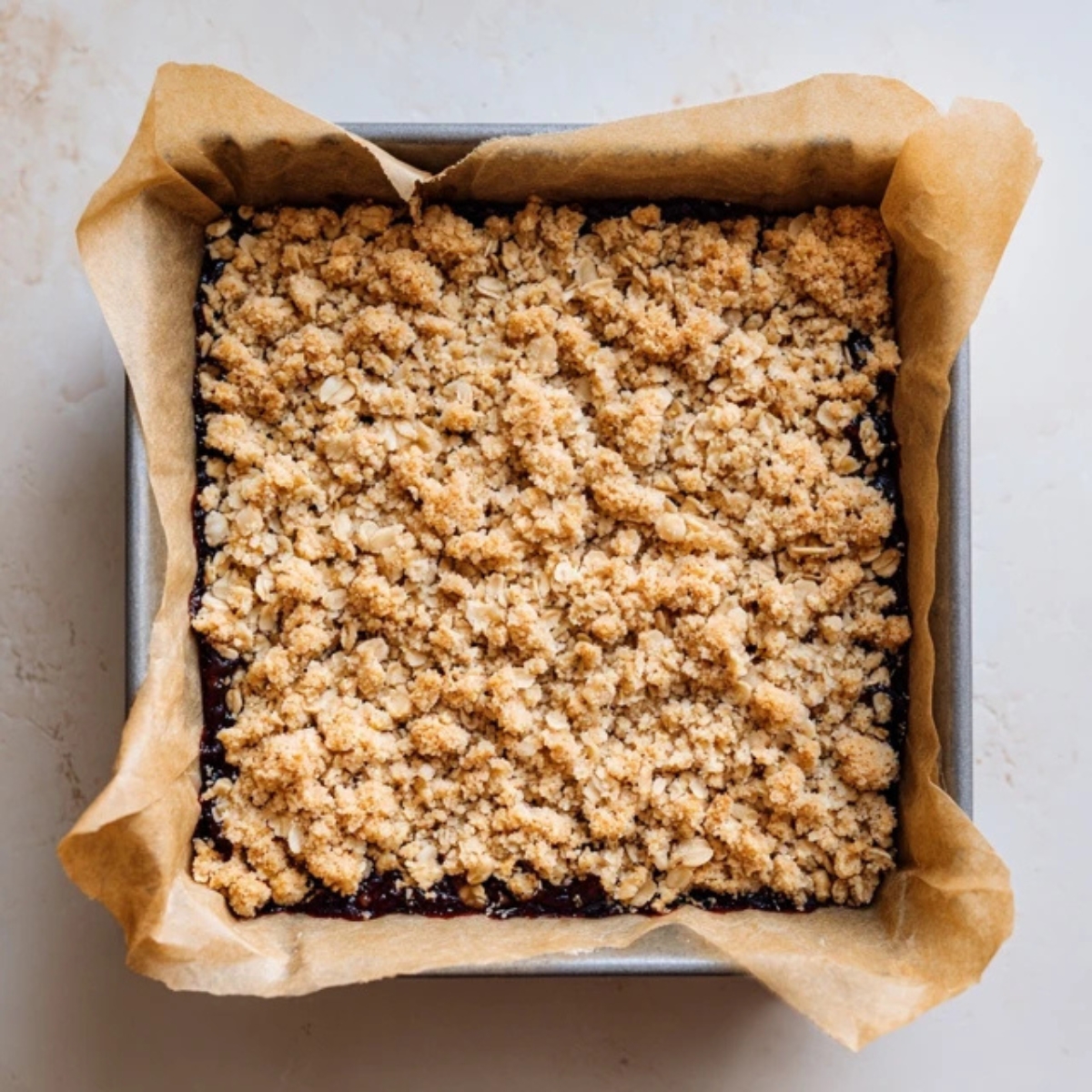 Closeup of fig bars layered in baking pan before baking