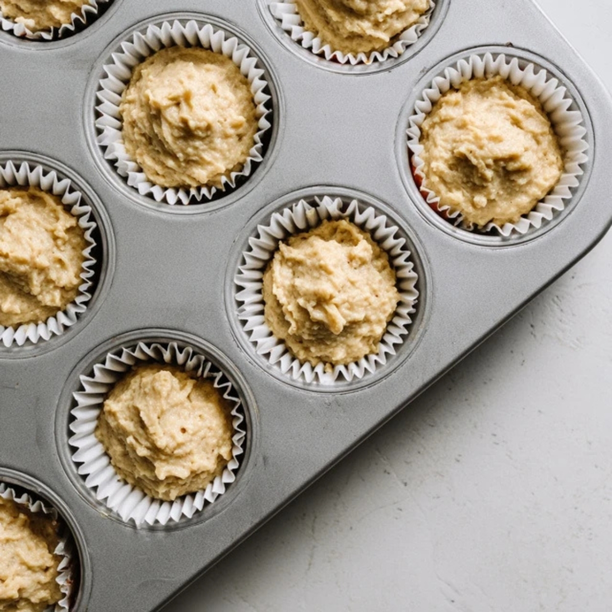 unbaked fig cupcake batter in muffin pan