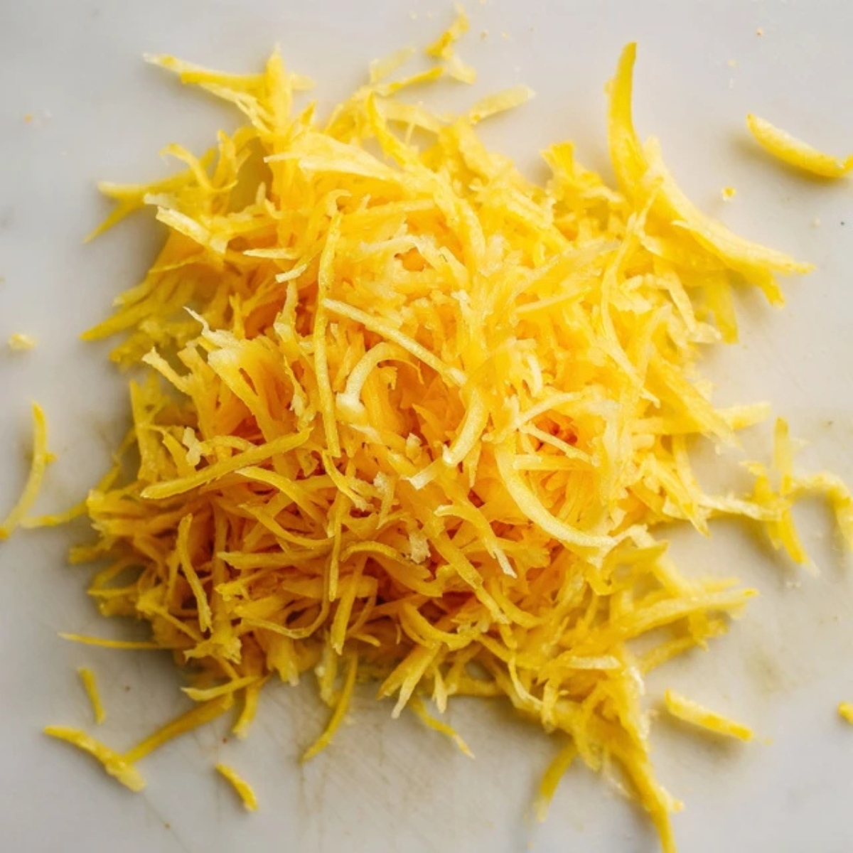 Freshly grated yellow squash close-up.