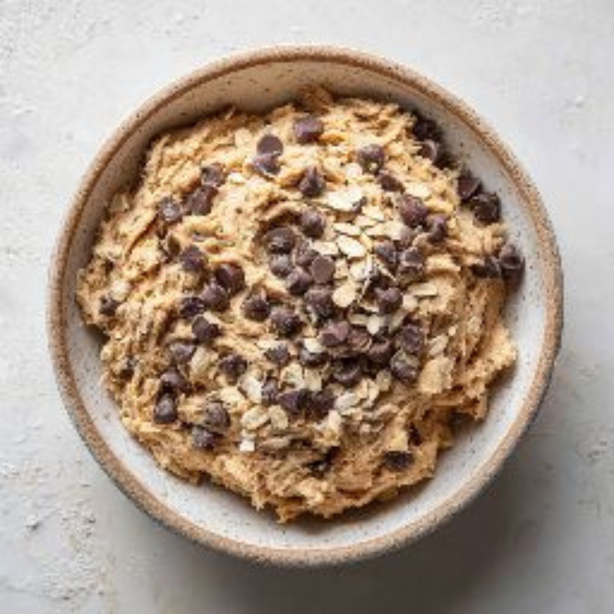 flour cinnamon and chocolate chips cookie dough in bowl