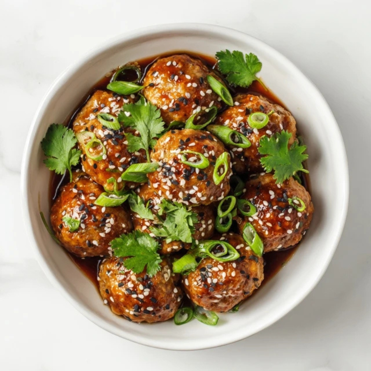 Sticky Asian turkey meatballs with soy glaze in white bowl