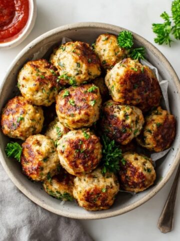 Crispy golden air fryer turkey meatballs with parsley and marinara