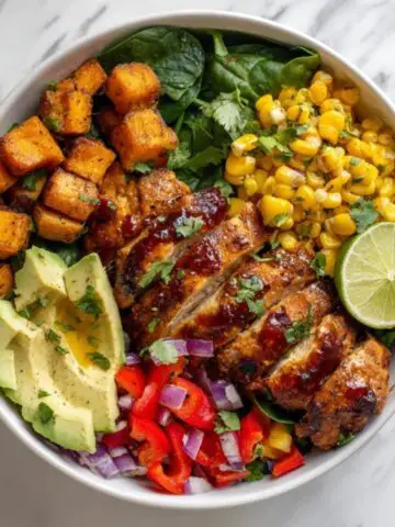 BBQ chicken sweet potato bowl with roasted sweet potatoes, avocado, and fresh veggies