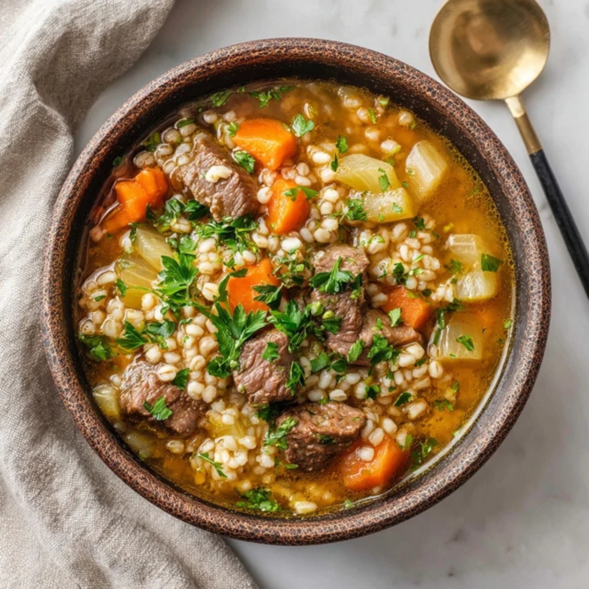 Hearty beef barley soup instant pot recipe in bowl with vegetables and barley