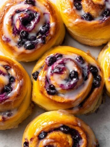Homemade blueberry sweet rolls with lemon glaze on kitchen counter