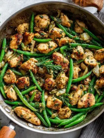 Healthy chicken and green beans skillet dinner on white counter