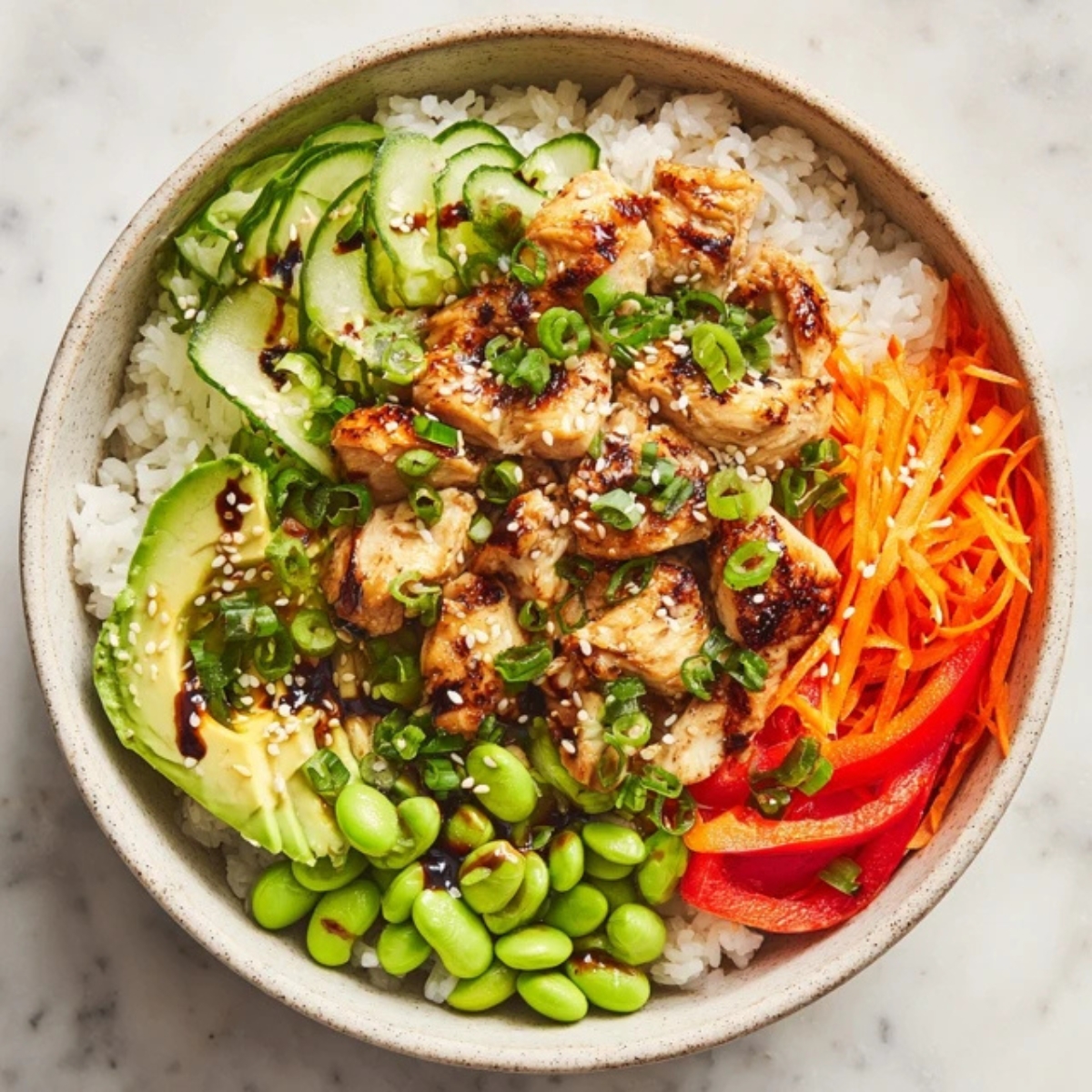 Chicken rice bowl with colorful vegetables and sesame soy sauce