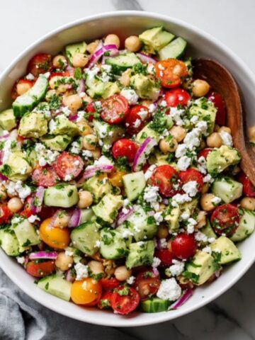 Mediterranean chickpea feta avocado salad in a white bowl